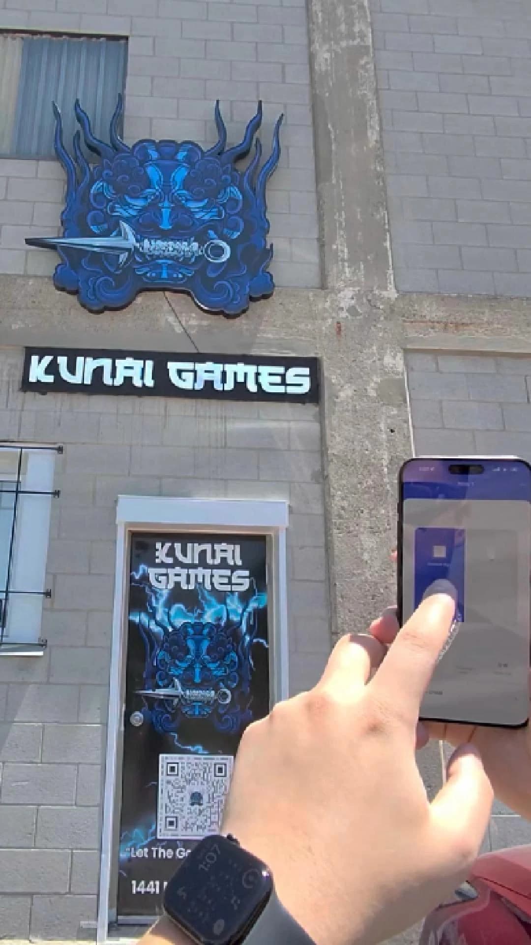 Kunai Games exterior signage illuminated while its control is operated from a phone